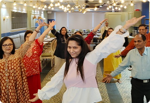 Group of people celebrating with arms up