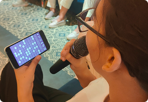 Person holding a microphone and phone